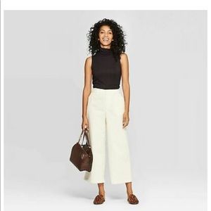 Cream corduroy pants.